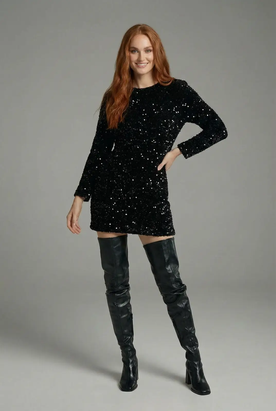 Studio portrait of a digital twin model in a sleek black outfit standing against a soft gray gradient.