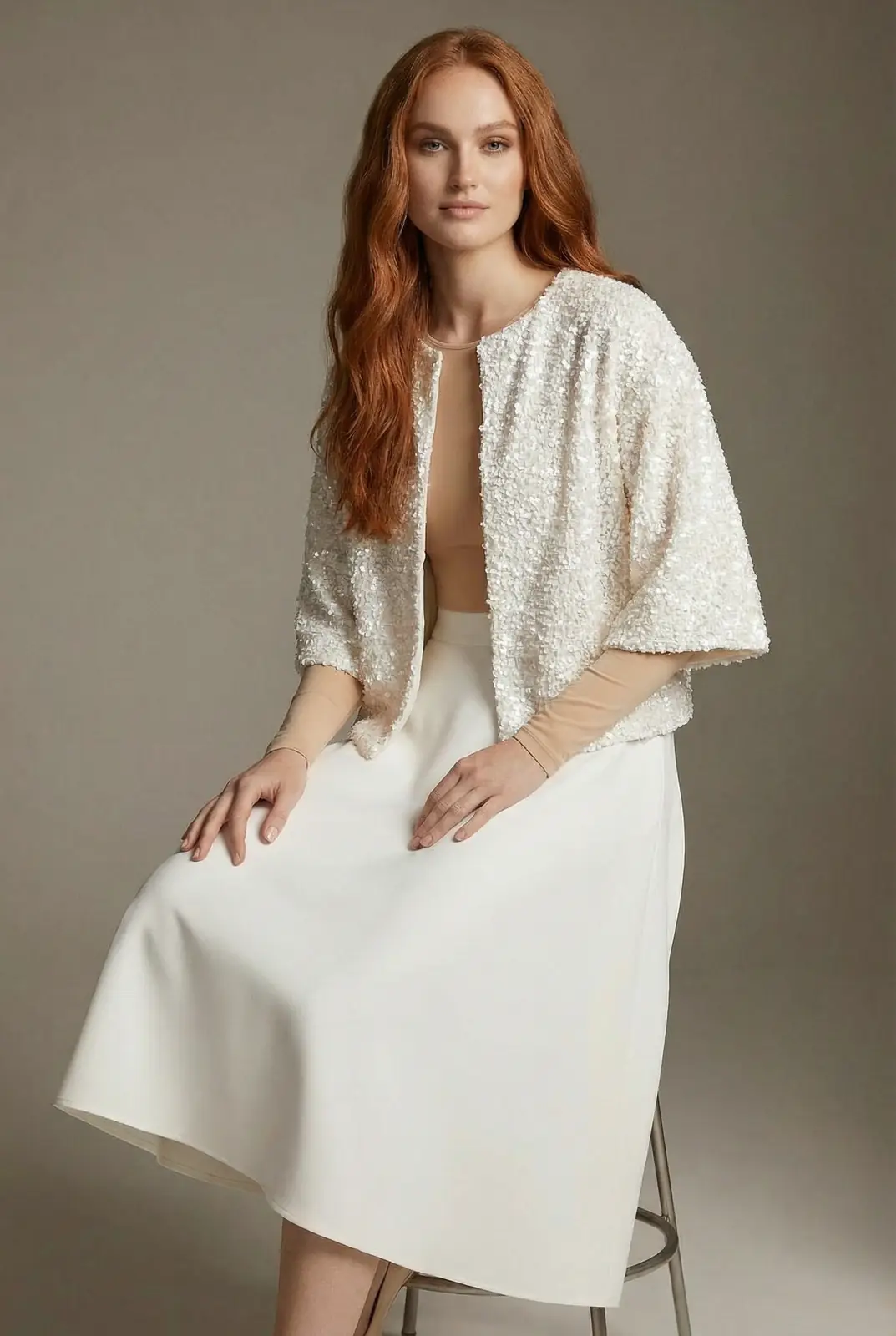 Studio portrait of a digital twin model in taupe outerwear against a softly lit gray backdrop.